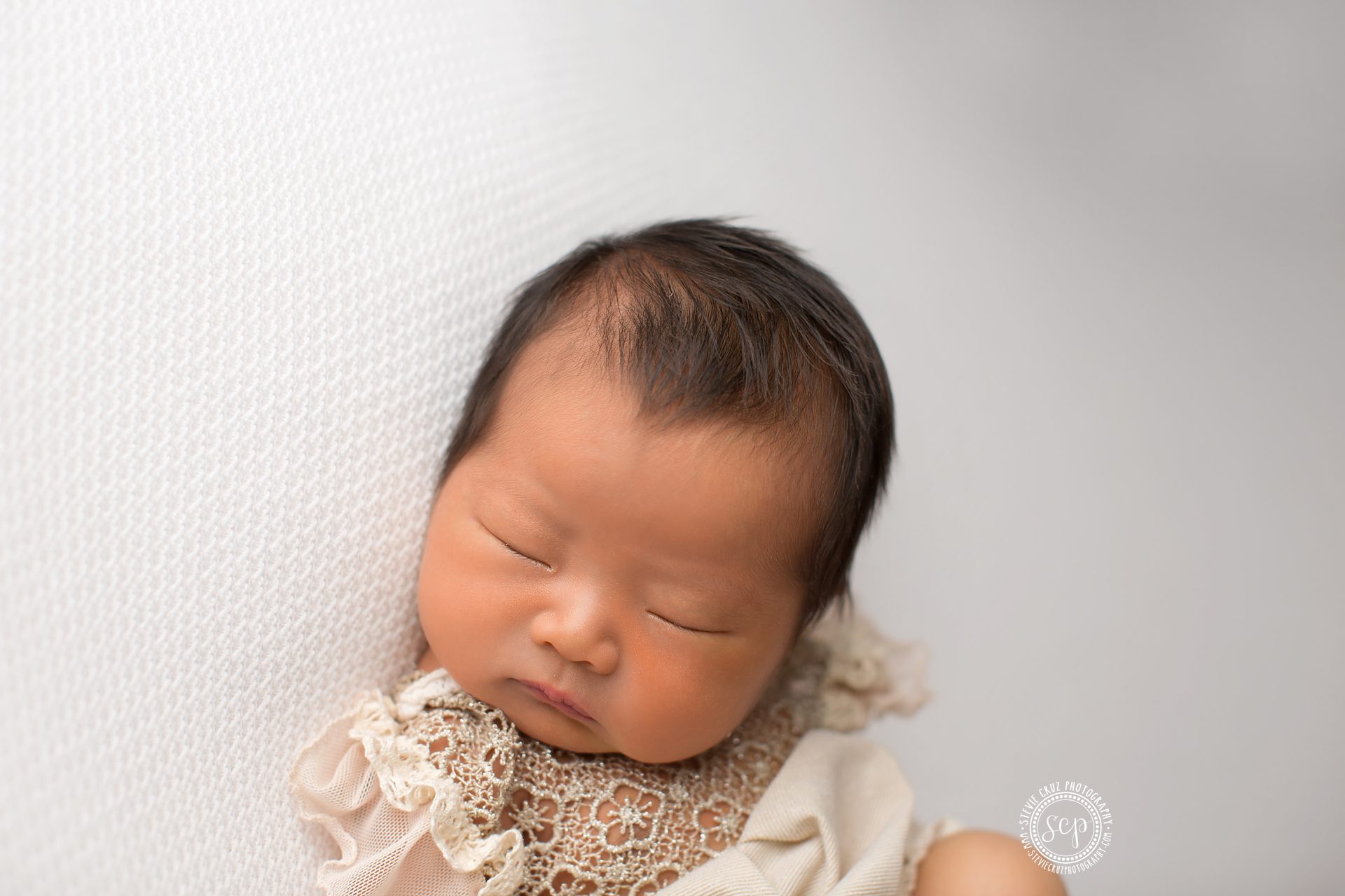 Precious baby girl sleeping during her newborn photo shoot in Yorba Linda CA