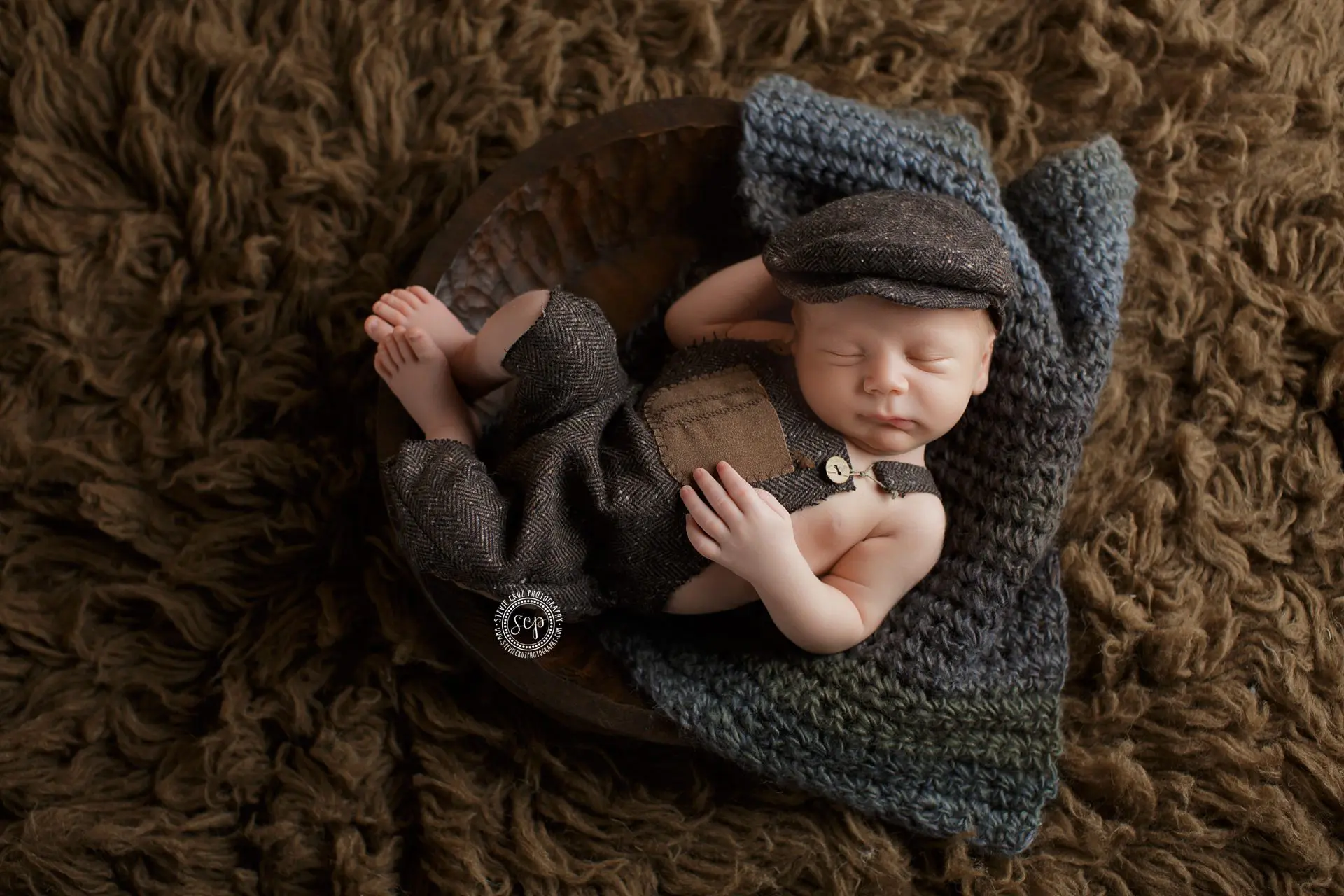 Sweet baby boy newborn photos in Yorba Linda CA. Love this vintage overalls and hat this newborn is wearing