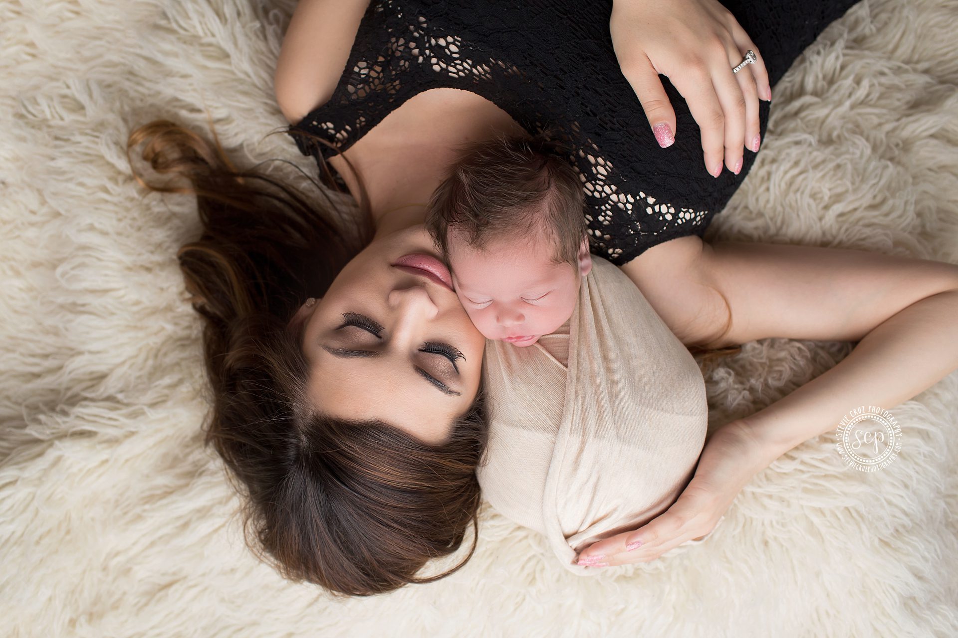 Mother lying down with newborn baby is my favorite parent with baby pose 