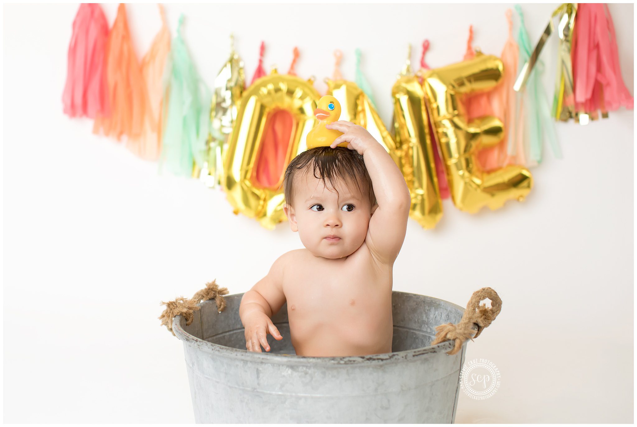 Rubber ducky cake smash and splash photo session to celebrate baby girl one year old birthday 