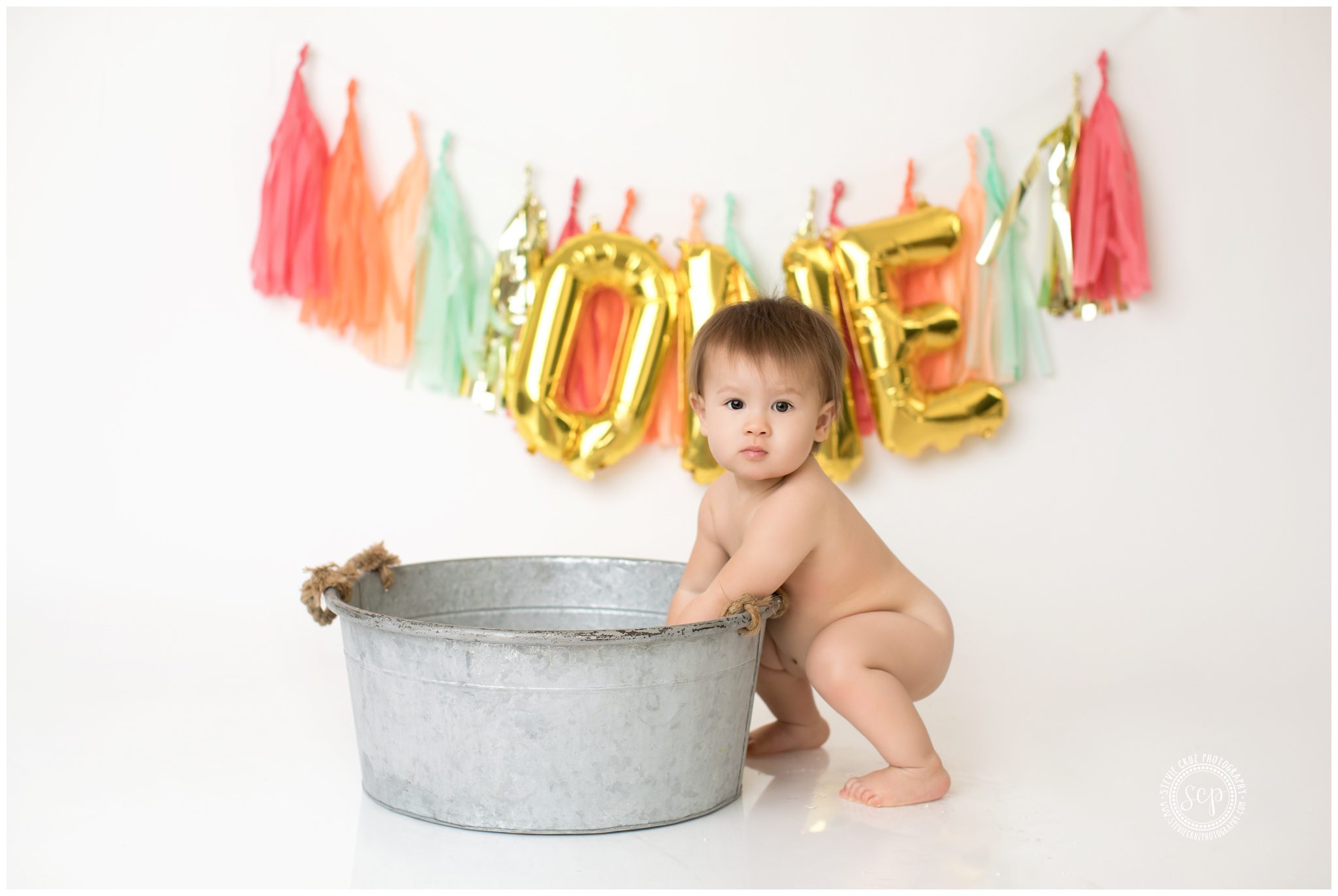 Love the props and one year gold gold balloon decor for this one year old birthday photo session taken in Orange County