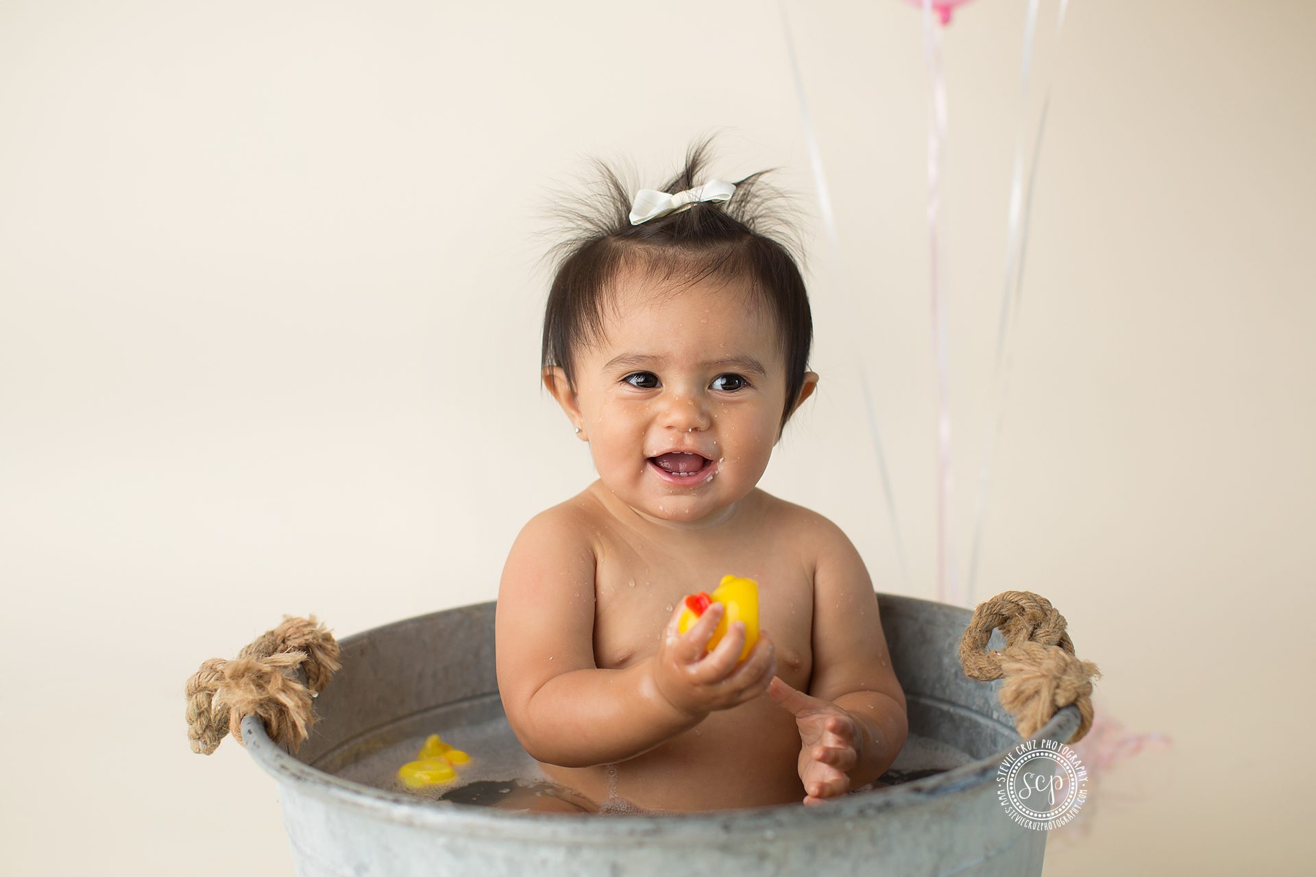 Unique cake smash photo ideas for little girls, a bubble bath with rubber duckies and all