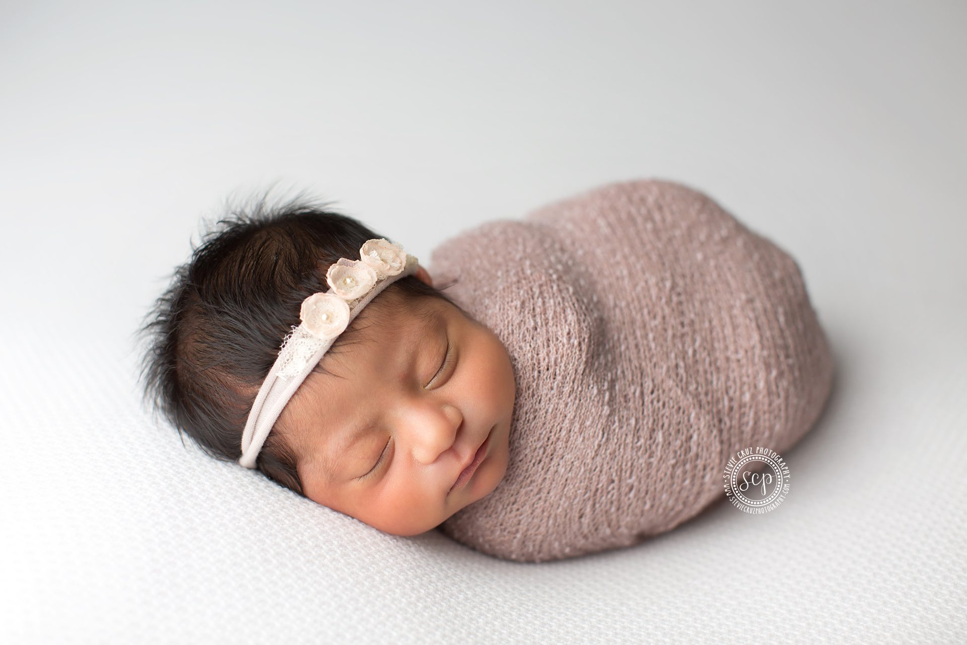 sleeping baby girl during her newborn photo session, love the cute head band