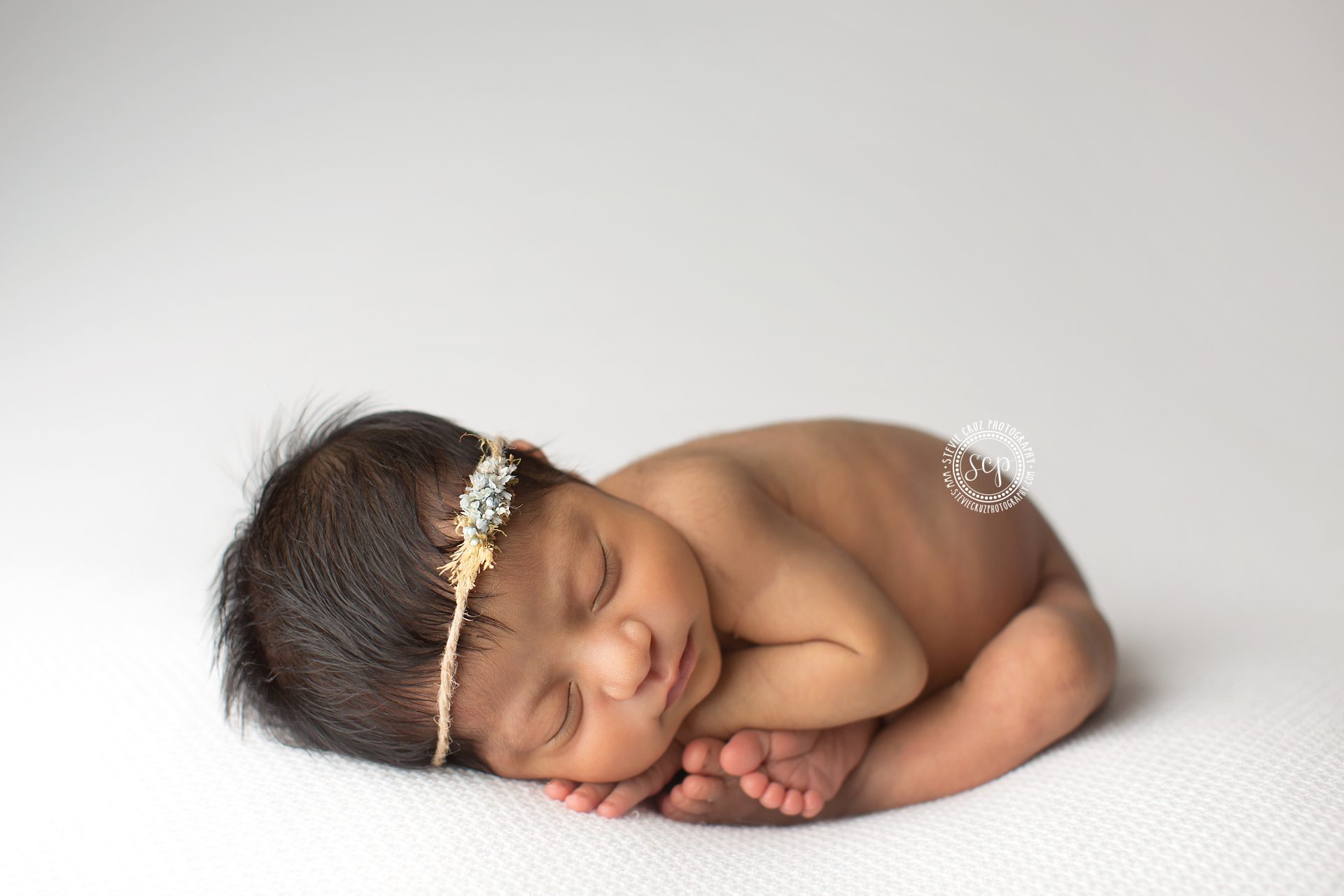 Souther California newborn photographer captures sleeping newborn baby girl. Love her hair accessory 