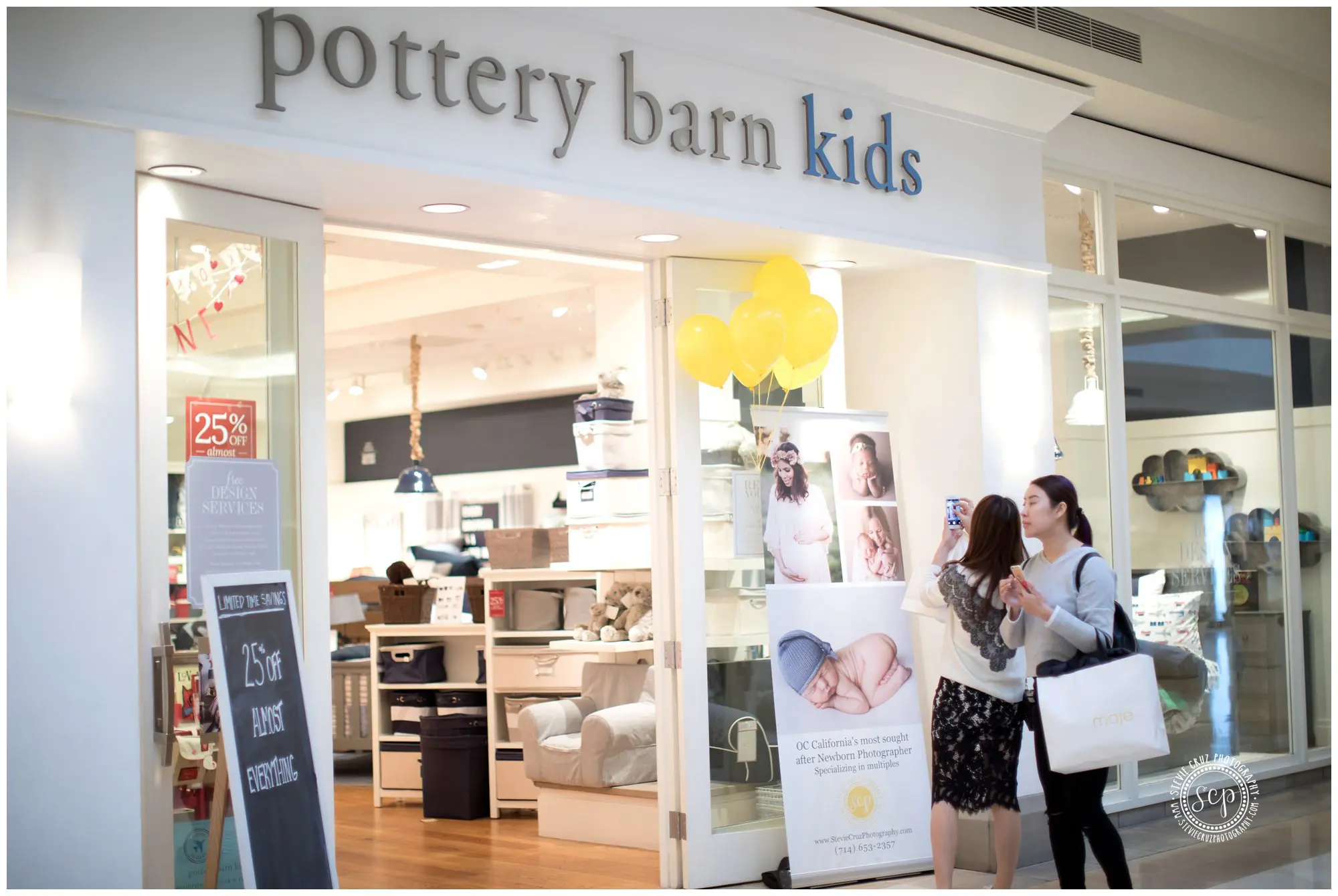 clients checking out Stevie Cruz Photography banner at Pottery Barn Kids